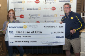 Craig Cowden of Brighthouse Enterprise presents a check to Robyn Matthews of Because of Ezra